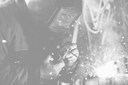 Worker with a protective mask using welding machine
